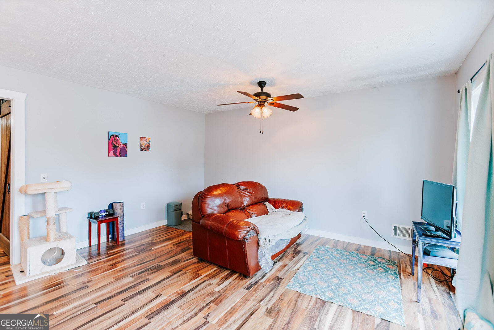 2820 Davis Academy Road Rutledge, GA 30663 - Photo 30 of 65 a living room with furniture and a wooden floor