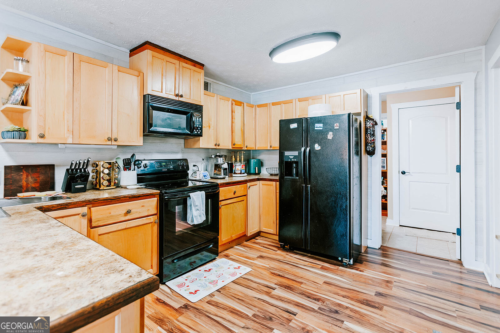 2820 Davis Academy Road Rutledge, GA 30663 - Photo 34 of 65 a kitchen with granite countertop a refrigerator stove top oven and sink