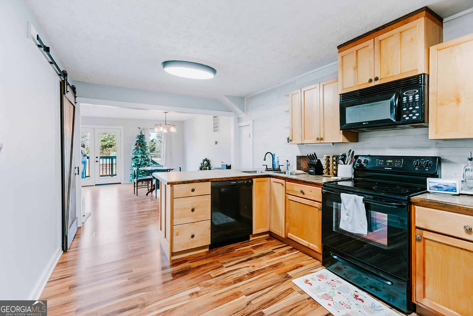 2820 Davis Academy Road Rutledge, GA 30663 - Photo 35 of 65 a kitchen with stainless steel appliances kitchen island granite countertop a stove a sink and a microwave