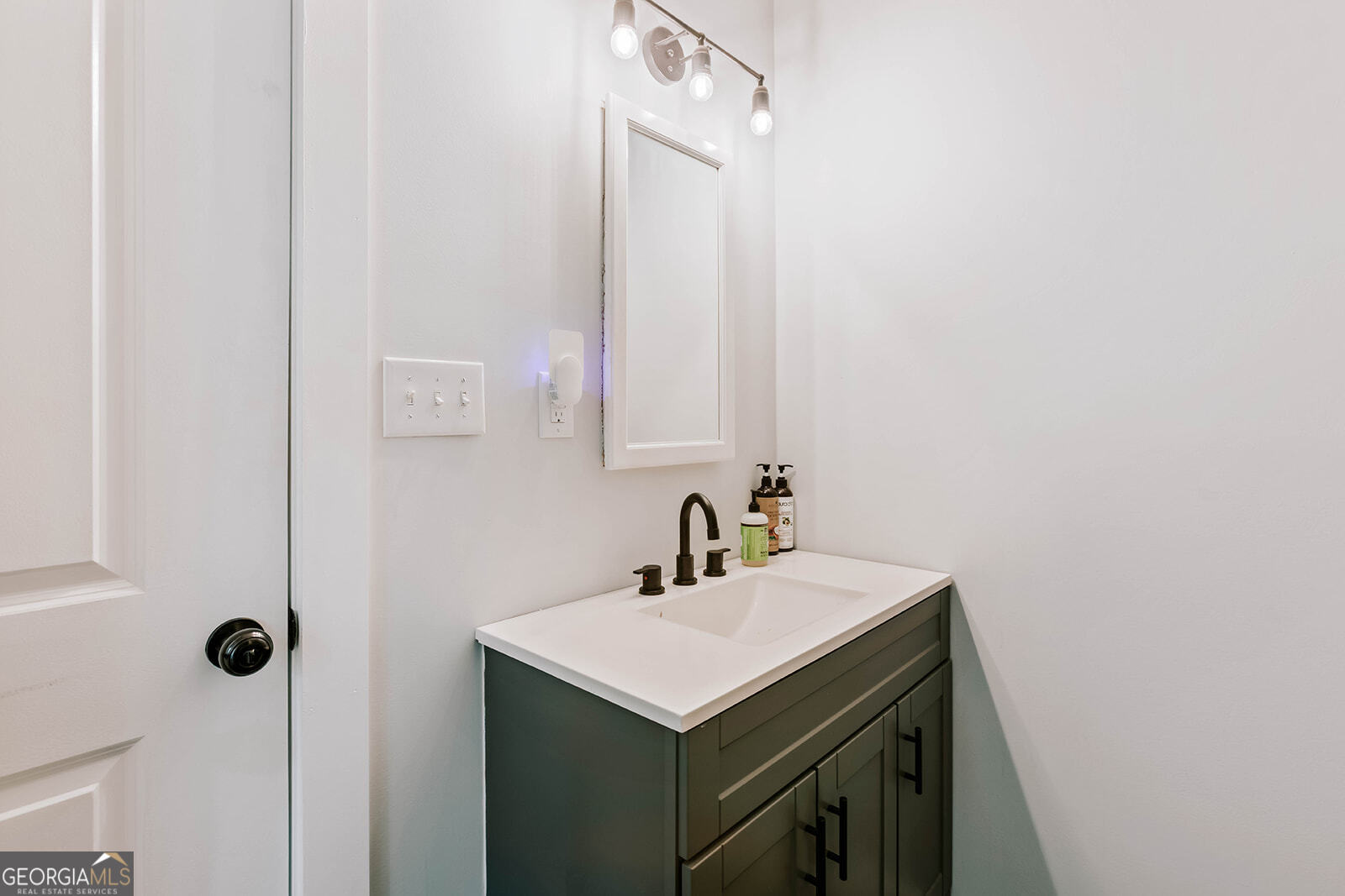 2820 Davis Academy Road Rutledge, GA 30663 - Photo 38 of 65 a bathroom with a sink and a mirror