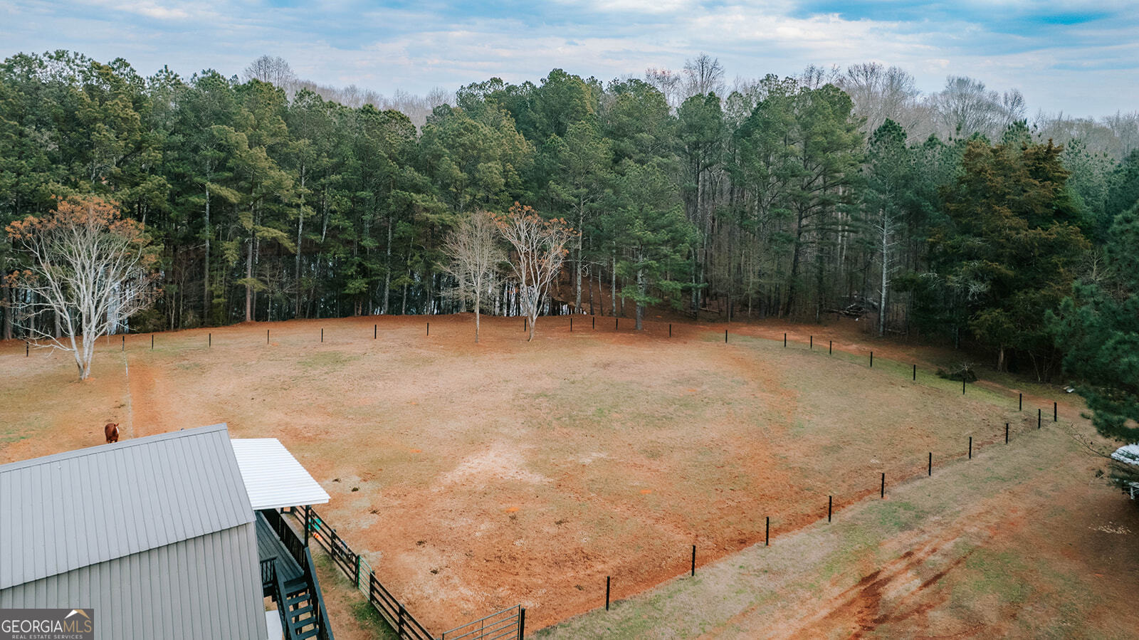 2820 Davis Academy Road Rutledge, GA 30663 - Photo 44 of 65 a backyard of a house with lots of green space and trees in the back