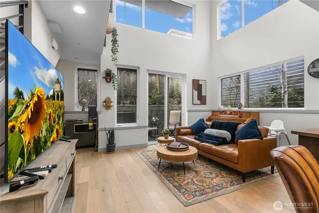 a living room with furniture ceiling fan and a rug