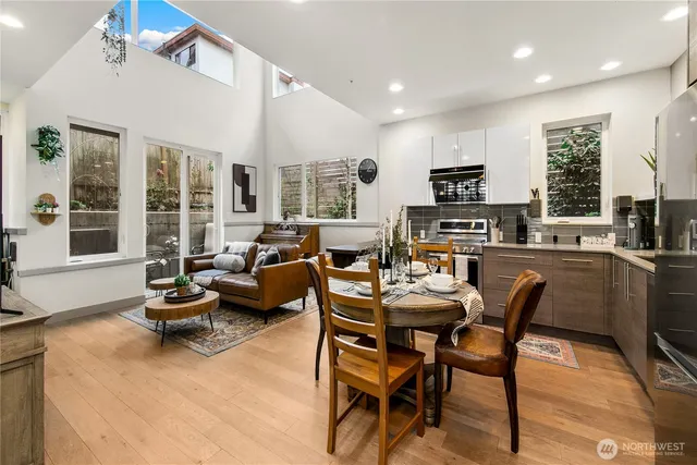 a living room with fireplace furniture and a large window