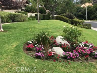 9 Evening Breeze Irvine, CA 92603 - Photo 21 of 30 a view of a garden with flowers and trees