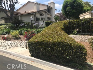 9 Evening Breeze Irvine, CA 92603 - Photo 4 of 30 a front view of a house with garden