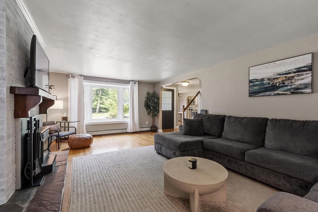 167 Gates Pond Road Berlin, MA 01503 - Photo 6 of 32 a living room with furniture a window and a chandelier