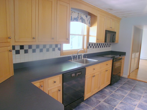 31 Ruthellen Road Framingham, MA 01701 - Photo 5 of 30 a kitchen with granite countertop a sink and a stove