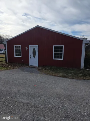 a view of a livingroom with wooden floor and window