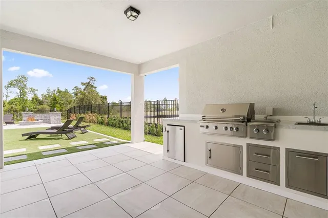 a view of a patio with table and chairs with wooden floor and fence
