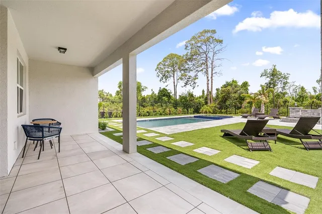 a view of a house with swimming pool and porch