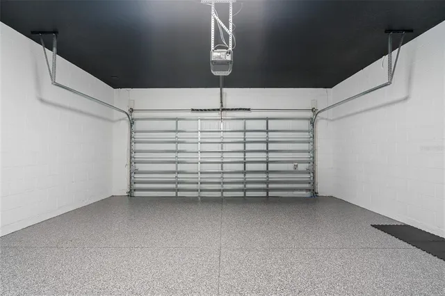 a living room with furniture and a view of kitchen