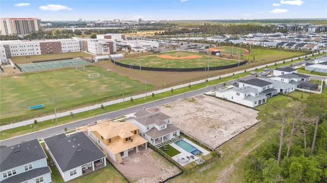 a front view of a house with a yard and potted plants