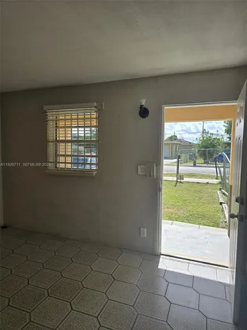 an empty room with outdoor view