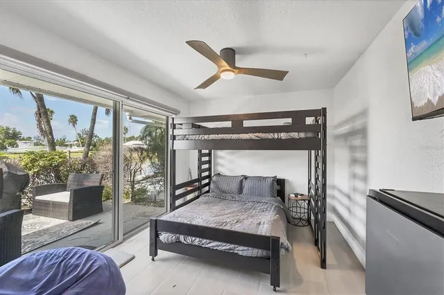 a bedroom with a bed and large window