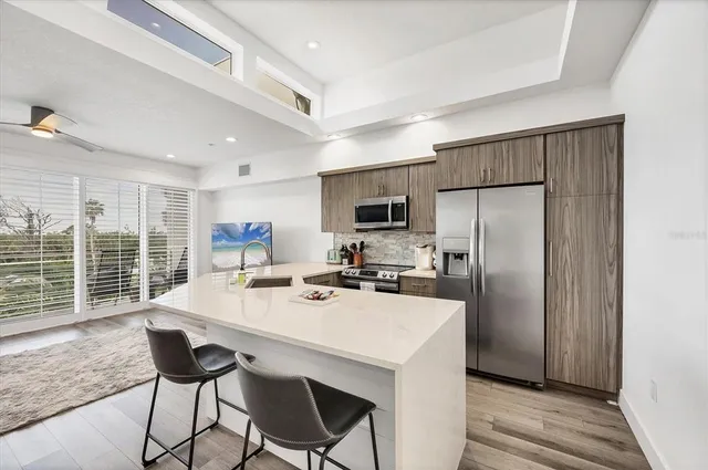 a kitchen with refrigerator cabinets dining table and chairs