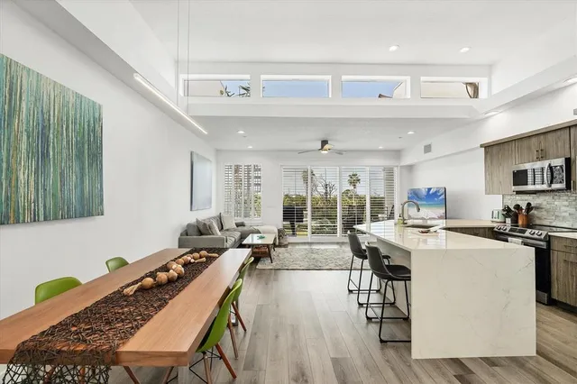 a living room with stainless steel appliances kitchen island granite countertop furniture and a kitchen view