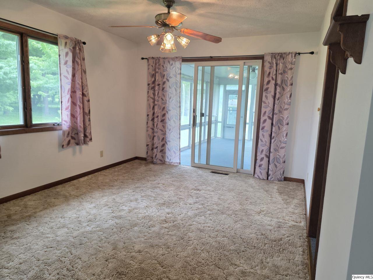 502 North Chestnut Street Versailles, IL 62378 - Photo 13 of 32 a view of empty room with floor to ceiling window