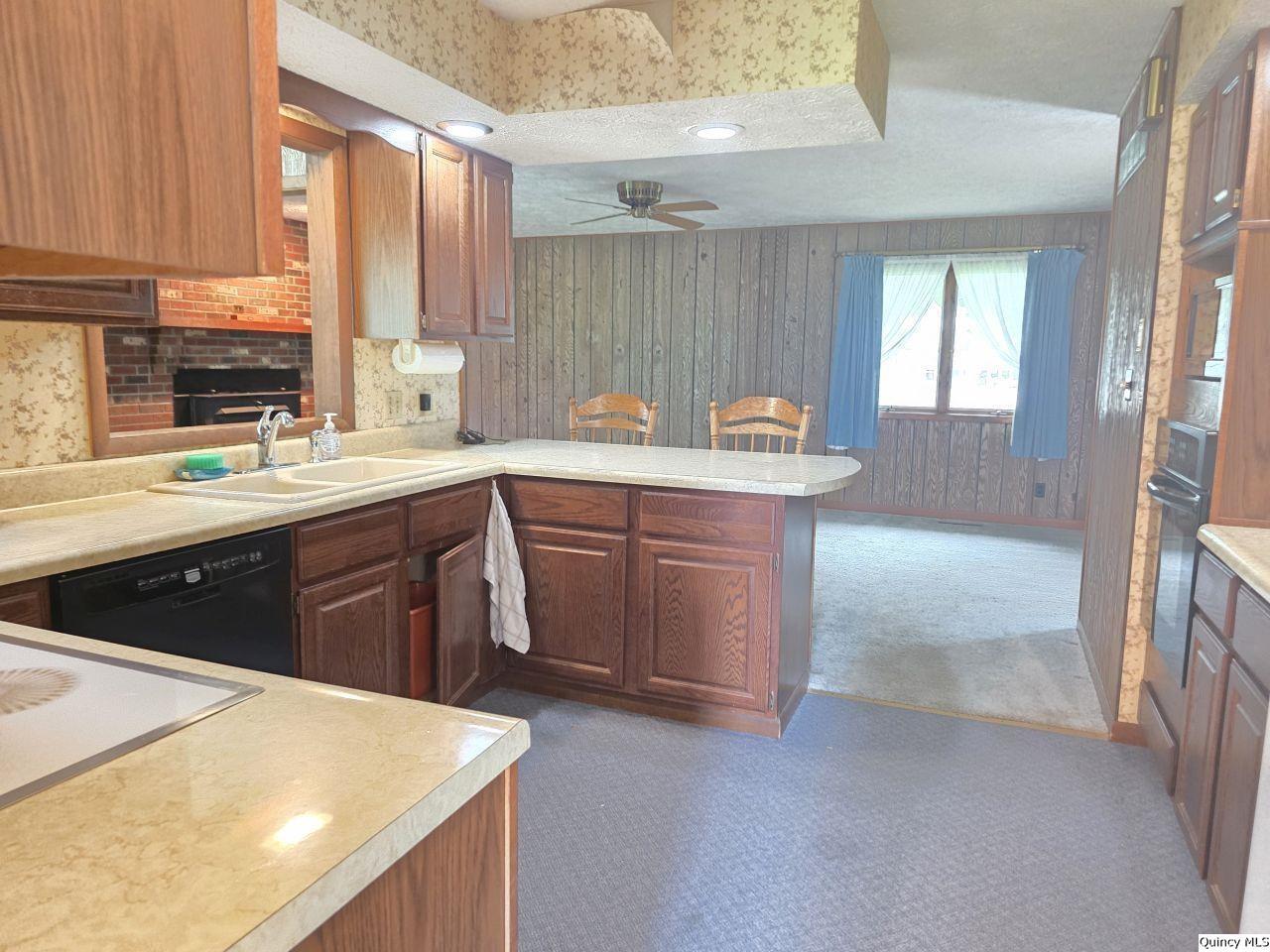 502 North Chestnut Street Versailles, IL 62378 - Photo 15 of 32 a kitchen with a sink a stove a refrigerator and cabinets