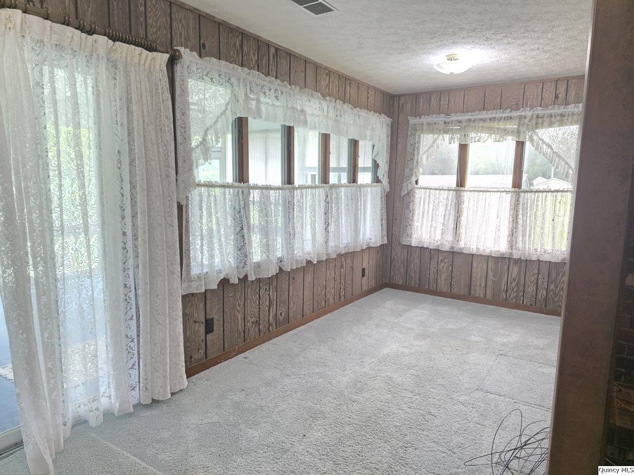 502 North Chestnut Street Versailles, IL 62378 - Photo 17 of 32 a view of an empty room with a window