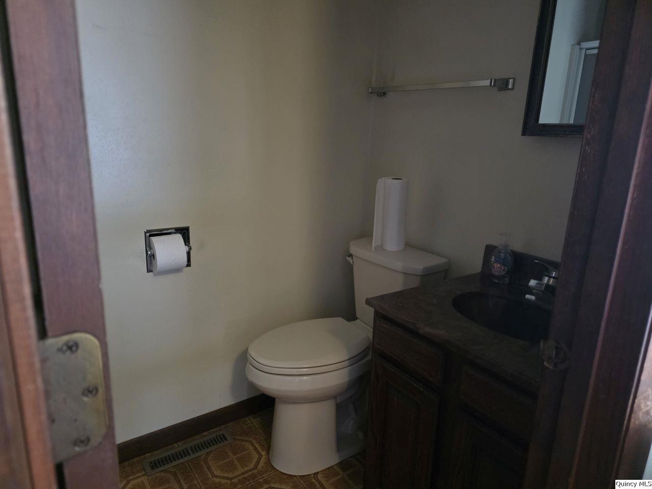502 North Chestnut Street Versailles, IL 62378 - Photo 22 of 32 a bathroom with a toilet and a sink
