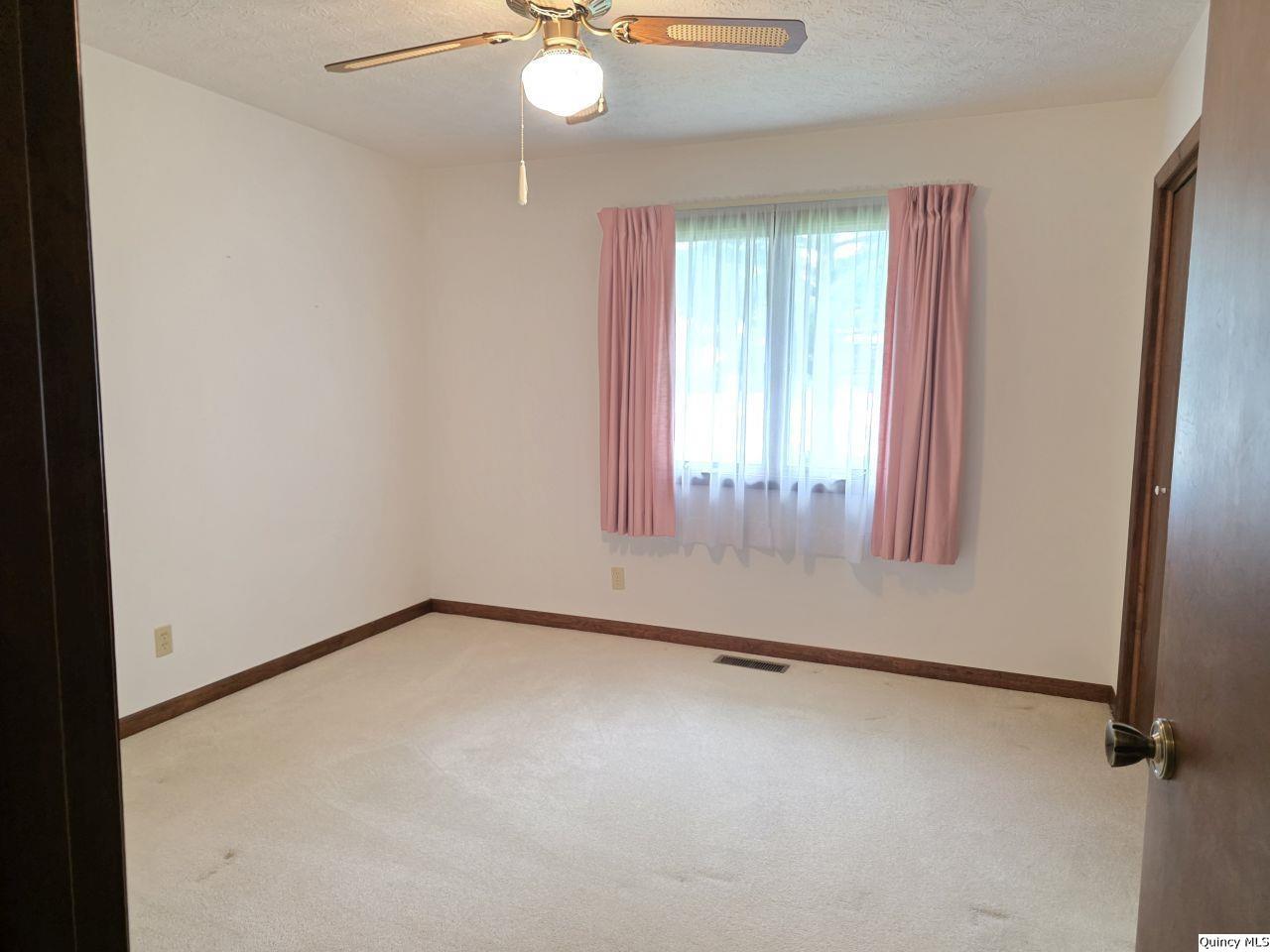 502 North Chestnut Street Versailles, IL 62378 - Photo 27 of 32 an empty room with window