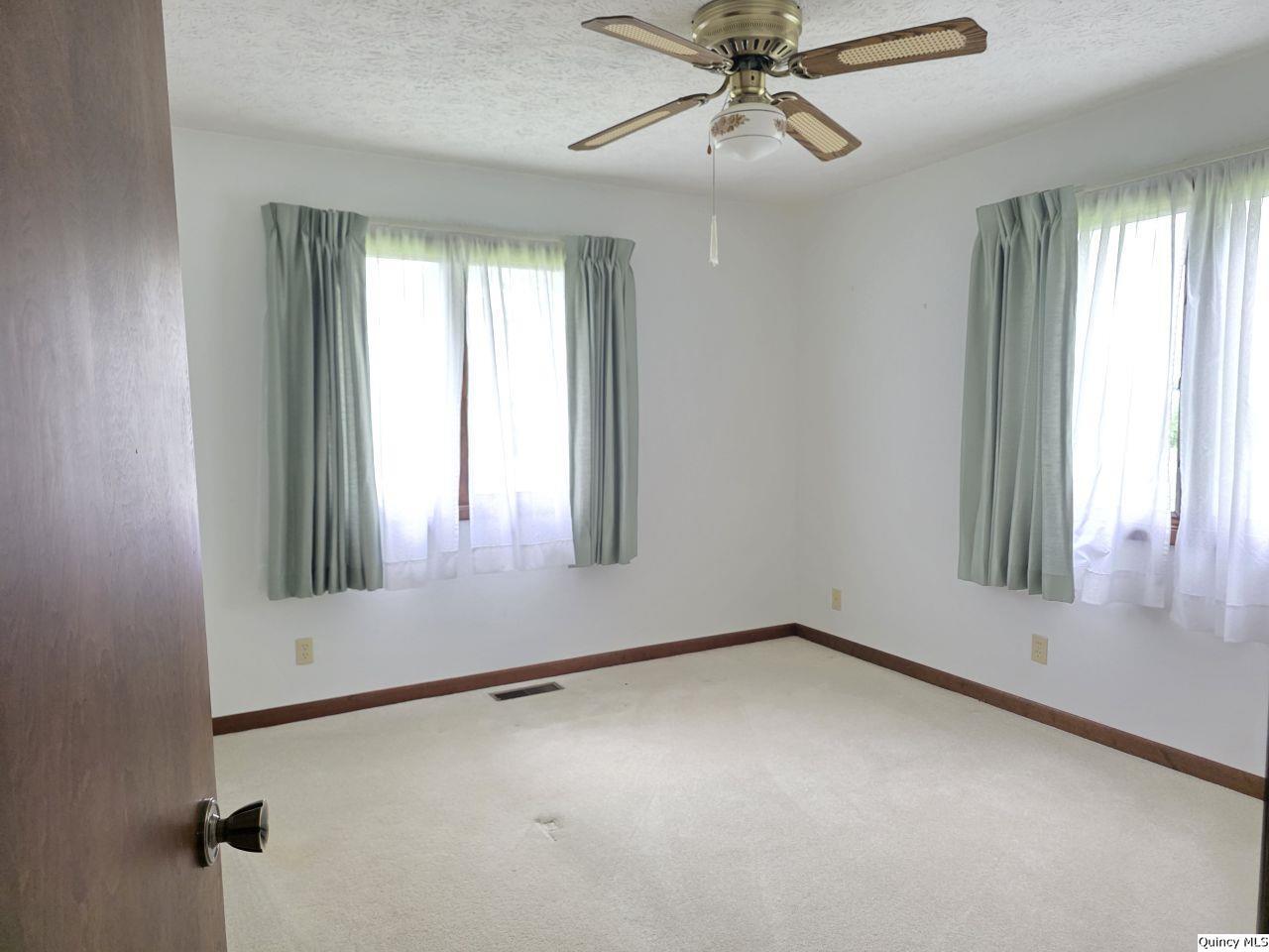502 North Chestnut Street Versailles, IL 62378 - Photo 28 of 32 an empty room with windows and fan