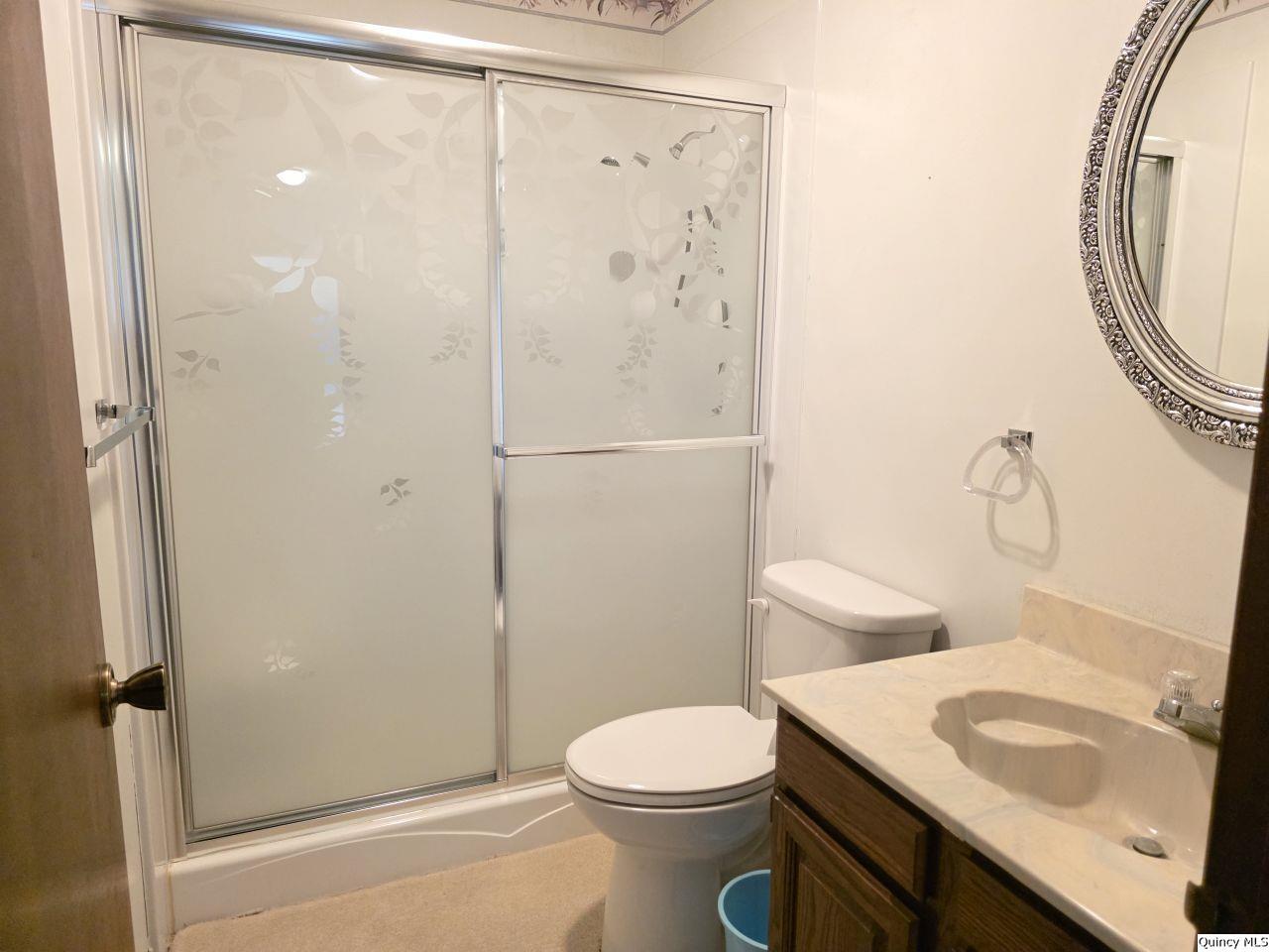 502 North Chestnut Street Versailles, IL 62378 - Photo 29 of 32 a white toilet sitting next to a bathroom sink