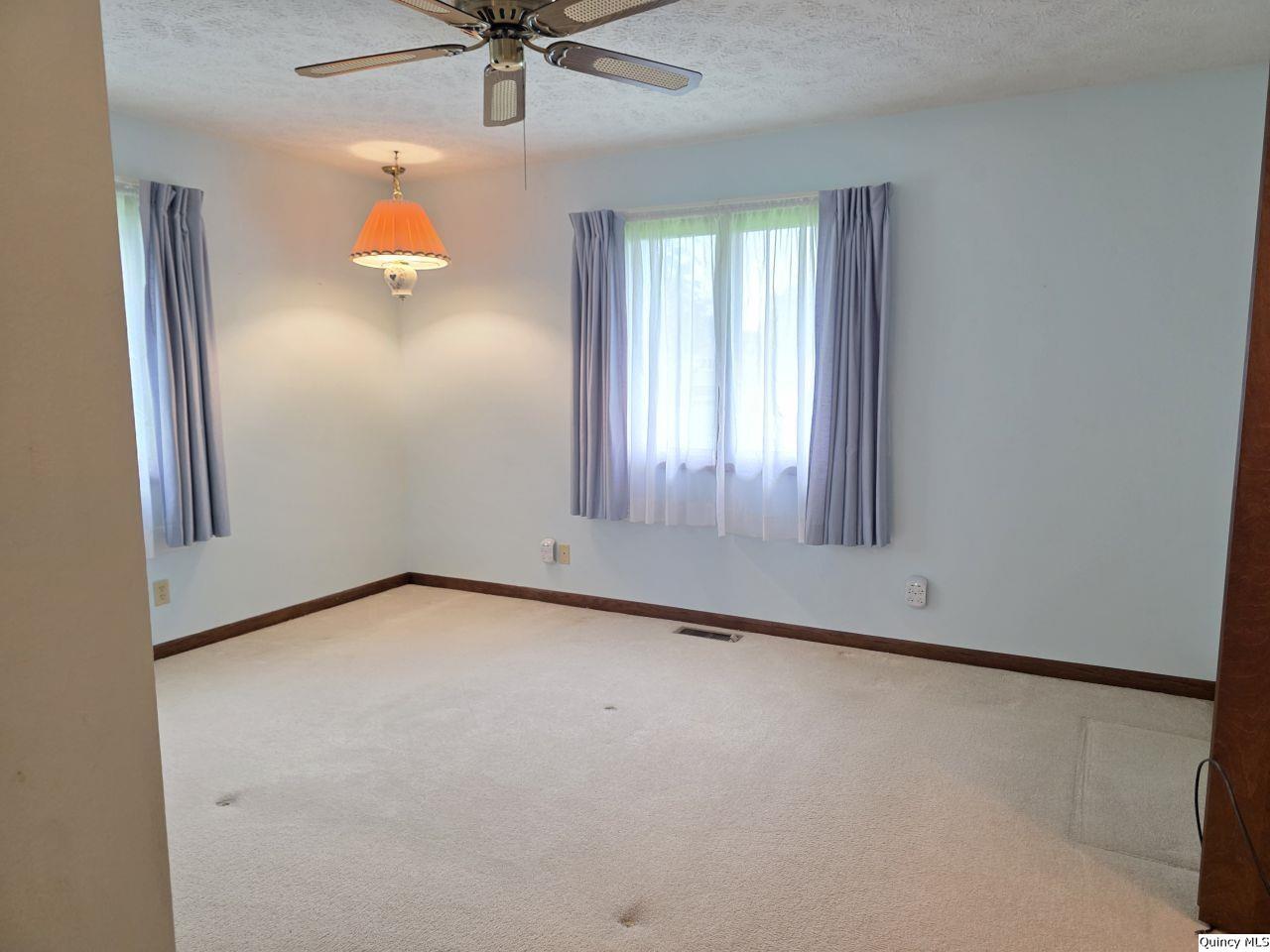 502 North Chestnut Street Versailles, IL 62378 - Photo 30 of 32 an empty room with a window and ceiling fan