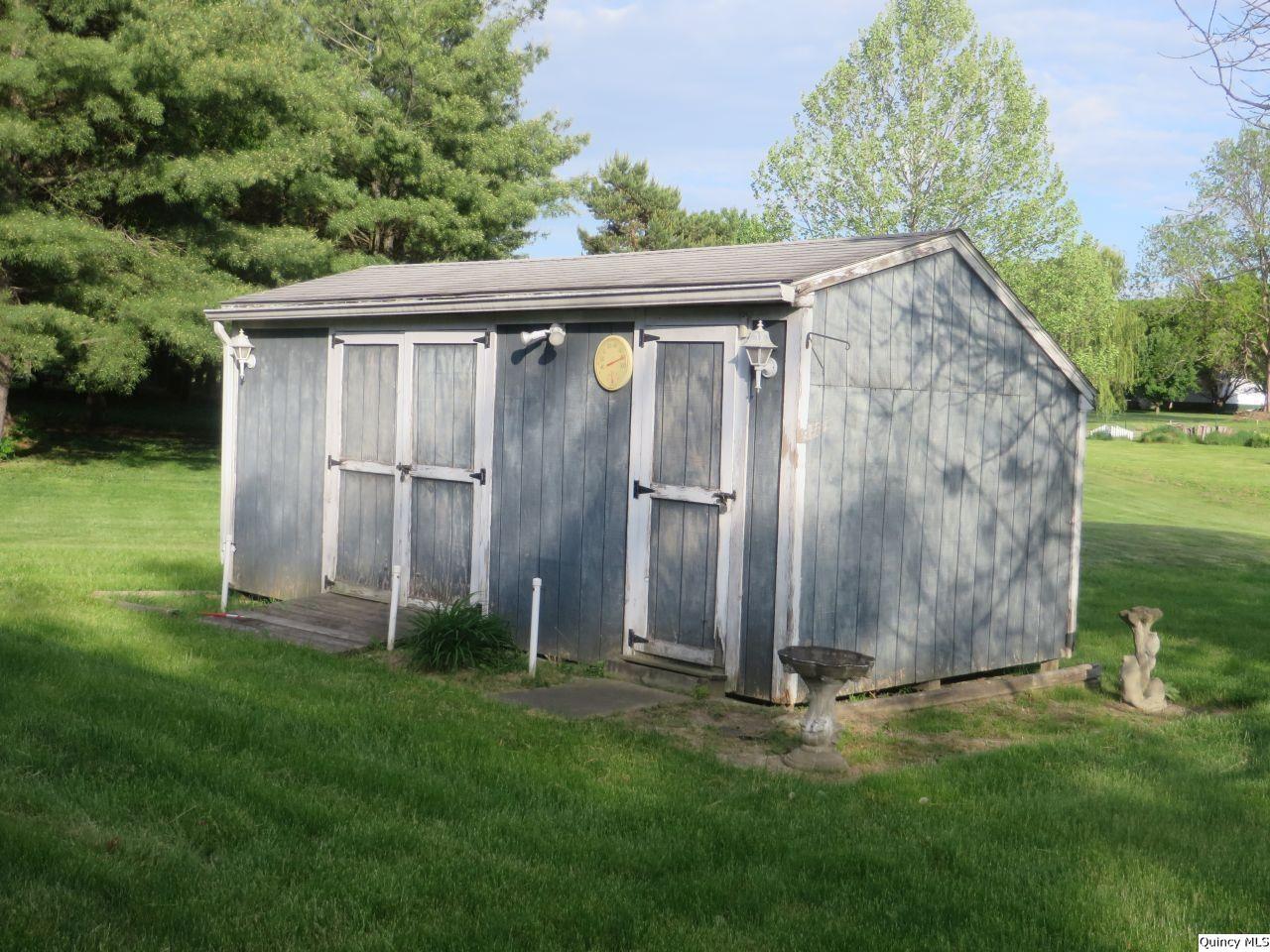 502 North Chestnut Street Versailles, IL 62378 - Photo 9 of 32 a view of a backyard with barn