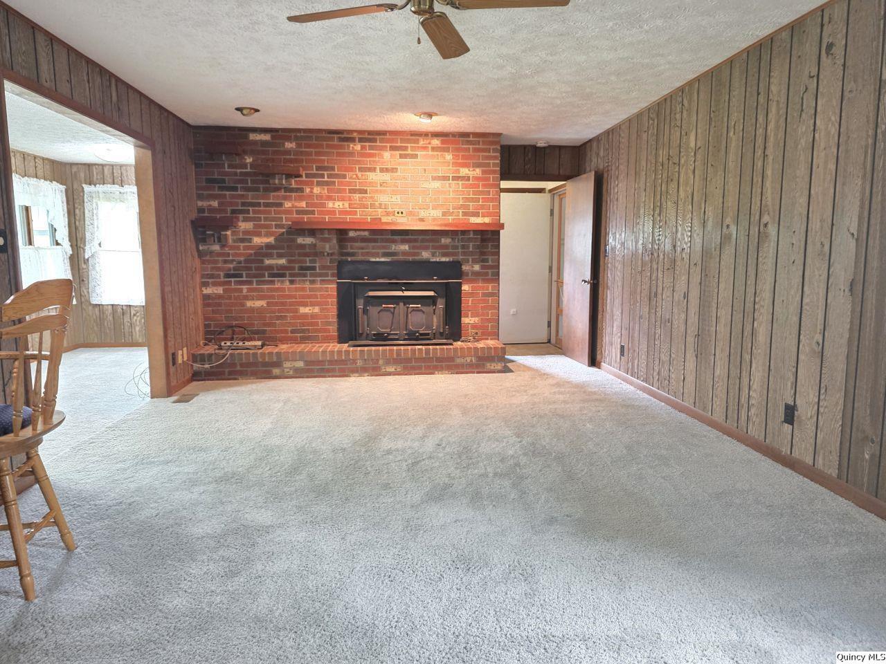 502 North Chestnut Street Versailles, IL 62378 - Photo 10 of 32 a view of an empty room with a fireplace