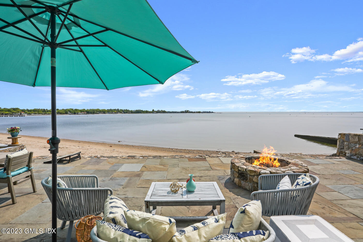 46 Ocean Drive North Stamford, CT 06902 - Photo 27 of 34 a view of a terrace with furniture and umbrella