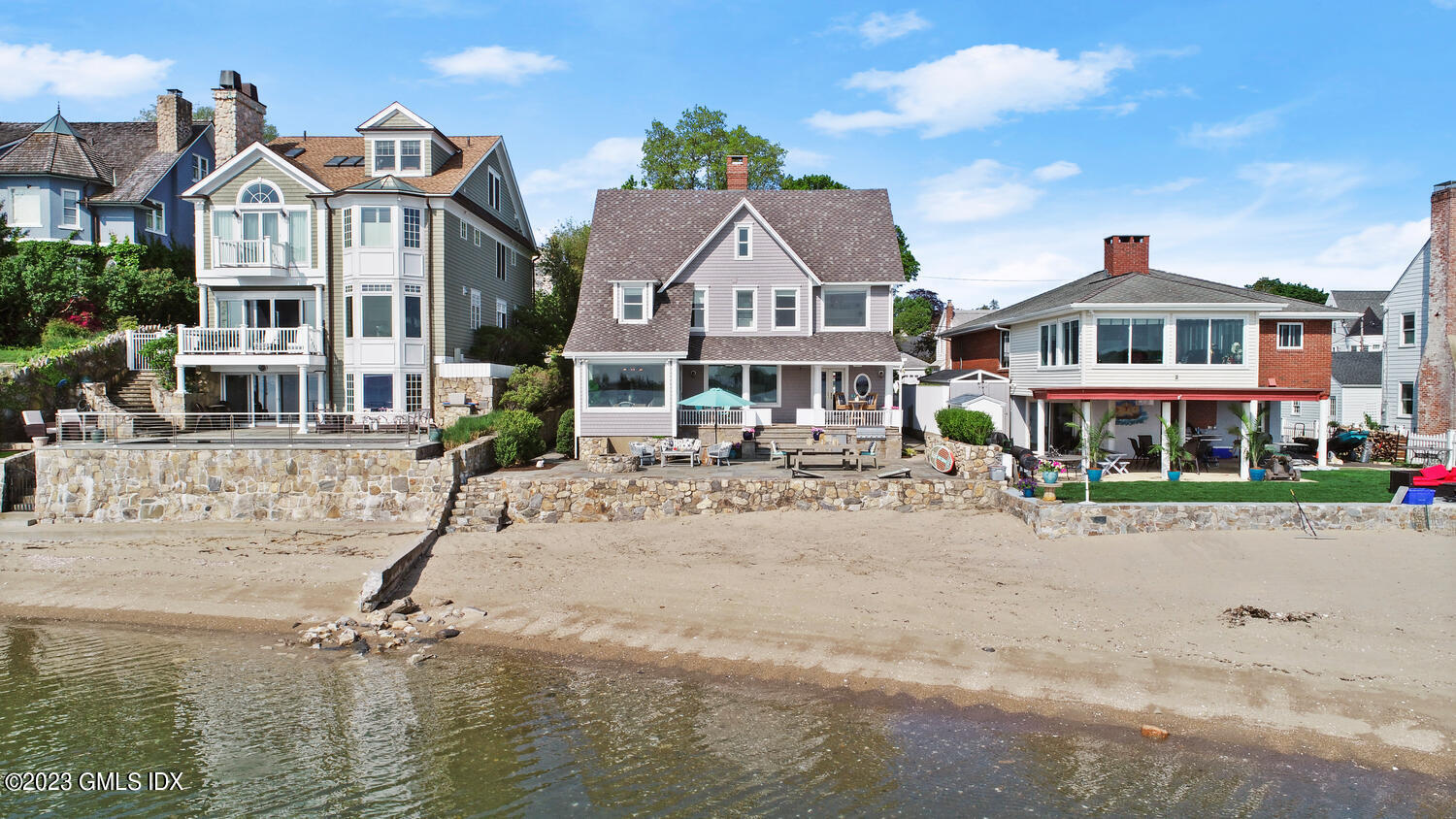 46 Ocean Drive North Stamford, CT 06902 - Photo 3 of 34 a view of a white house with a yard