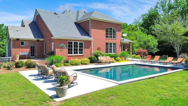 a view of a lake with a house swimming pool and outdoor space