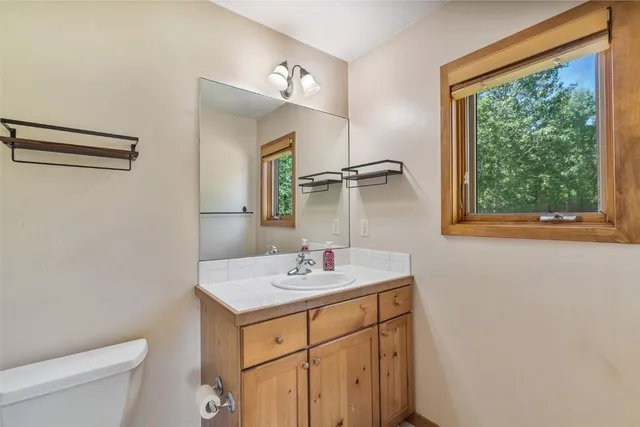 a bedroom with a bed and a ceiling fan