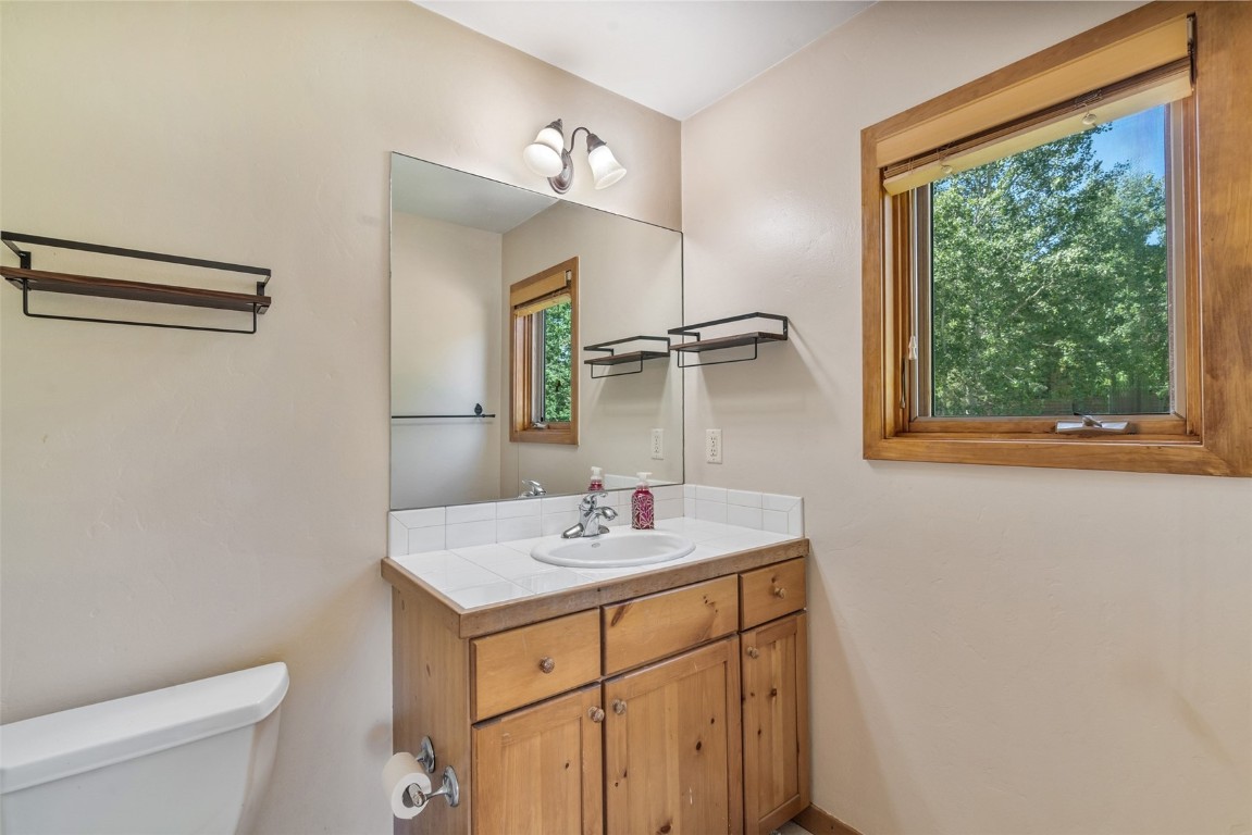12 Raindance Trail Dillon, CO 80435 - Photo 25 of 47 a bathroom with a sink vanity granite toilet and a mirror