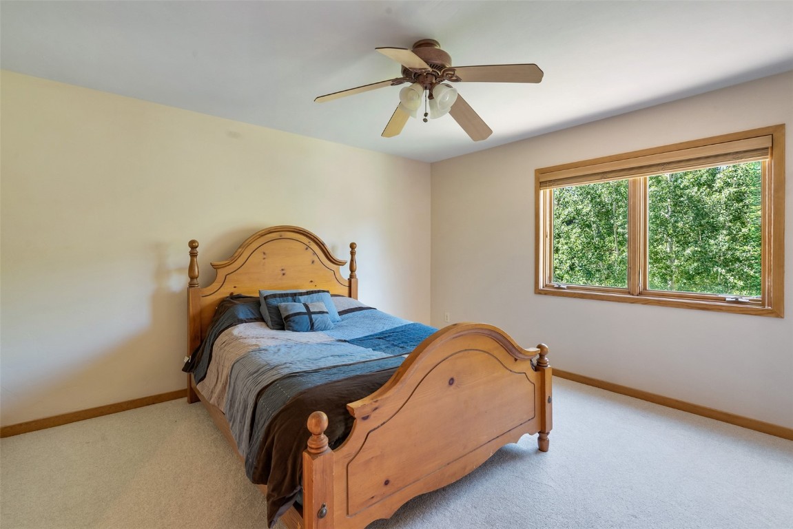 12 Raindance Trail Dillon, CO 80435 - Photo 26 of 47 a bedroom with a bed and a ceiling fan