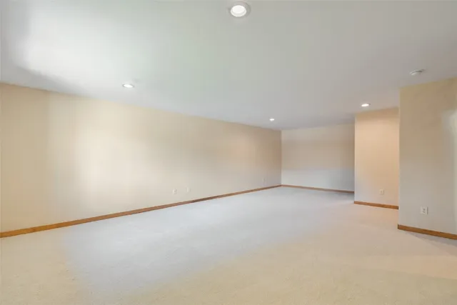 an empty room with windows and closet area
