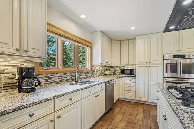 a kitchen with a sink cabinets and window