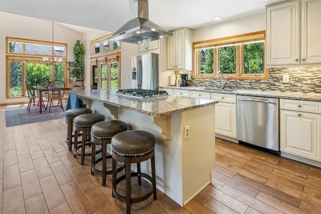 a kitchen with sink cabinets and dining table