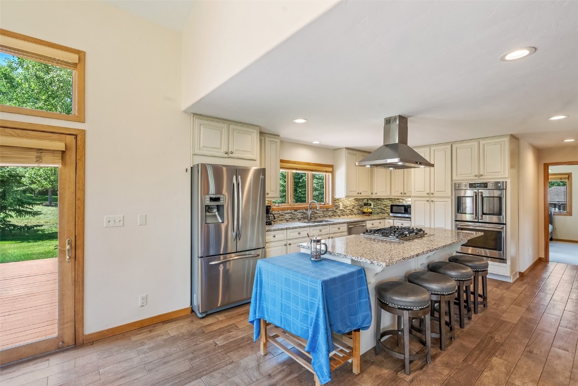 12 Raindance Trail Dillon, CO 80435 - Photo 10 of 47 a kitchen with stainless steel appliances a refrigerator a stove a sink a dining table and chairs with wooden floor