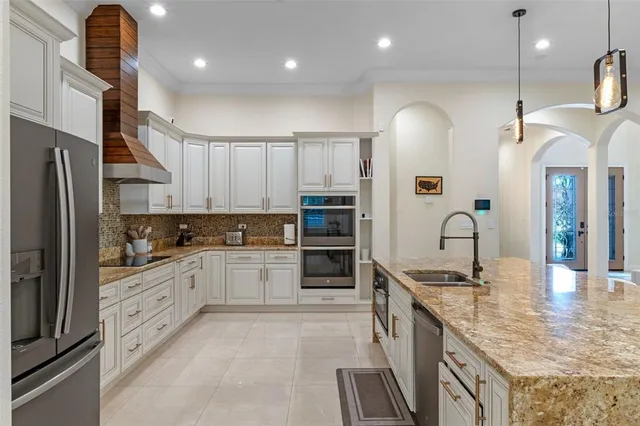 a kitchen with a refrigerator and a sink