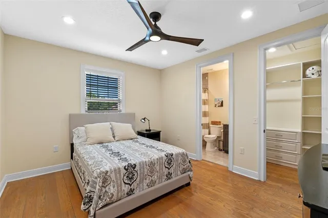 a bathroom with a granite countertop sink a toilet and a mirror