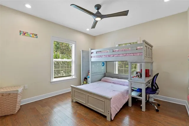 a bathroom with a granite countertop sink a mirror and a shower