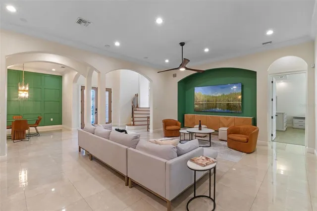 a living room with furniture a window and a clock