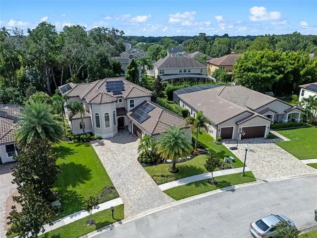 an aerial view of residential houses with outdoor space and street view