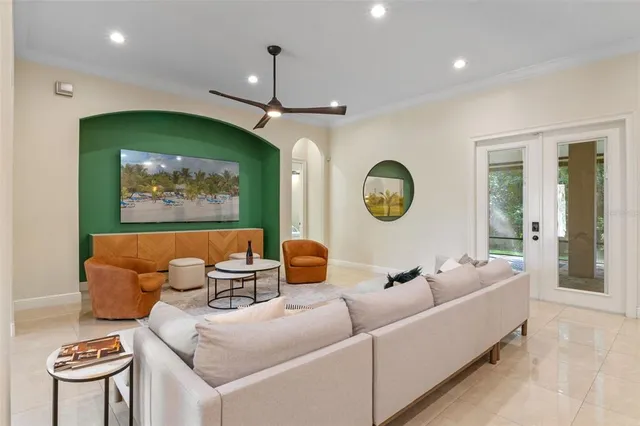 a living room with furniture a rug and a chandelier