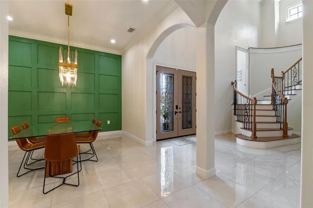 a large kitchen with stainless steel appliances granite countertop a stove a sink dishwasher a dining table and chairs with wooden floor