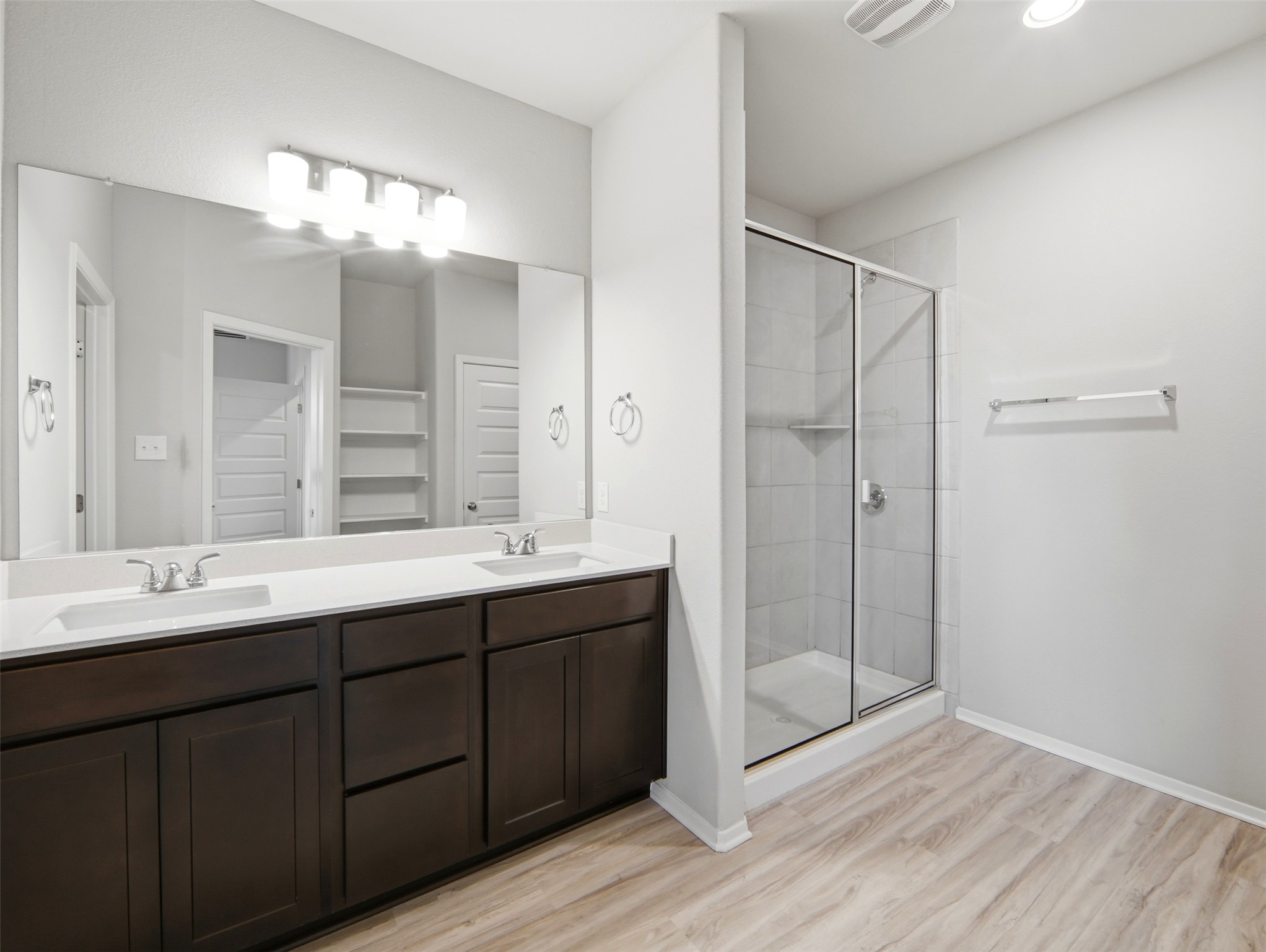 60 Bent Trl Lane Georgetown, TX 78628 - Photo 27 of 40 Dual vanities and a glass-enclosed shower create a practical, clean bathroom.