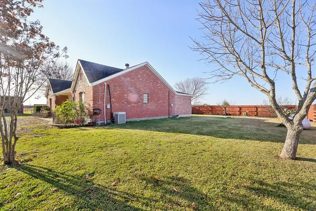 a front view of house with yard and trees