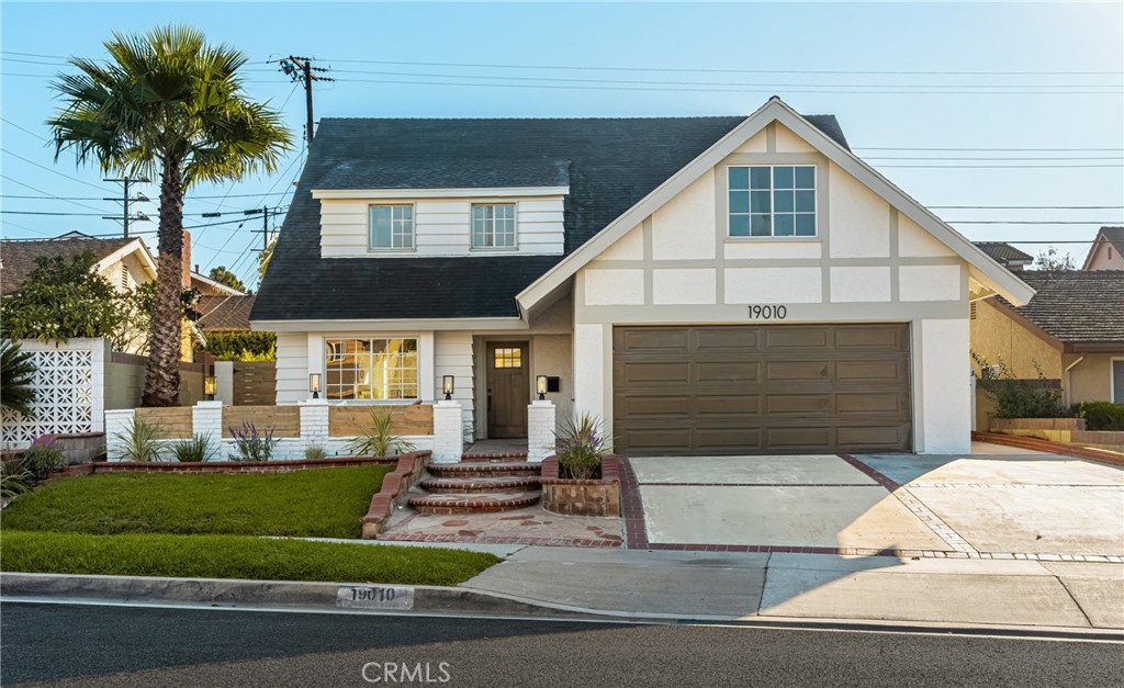 19010 Gunlock Avenue Carson, CA 90746 - Photo 1 of 1 a front view of a house with a yard and garage